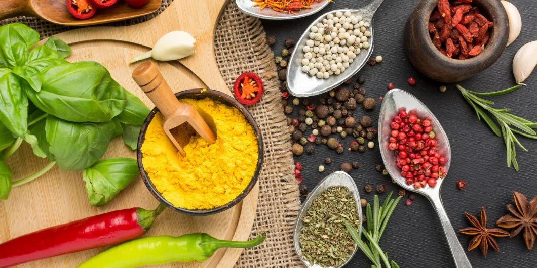 Spices and herbs infusing in alcohol in glass jar